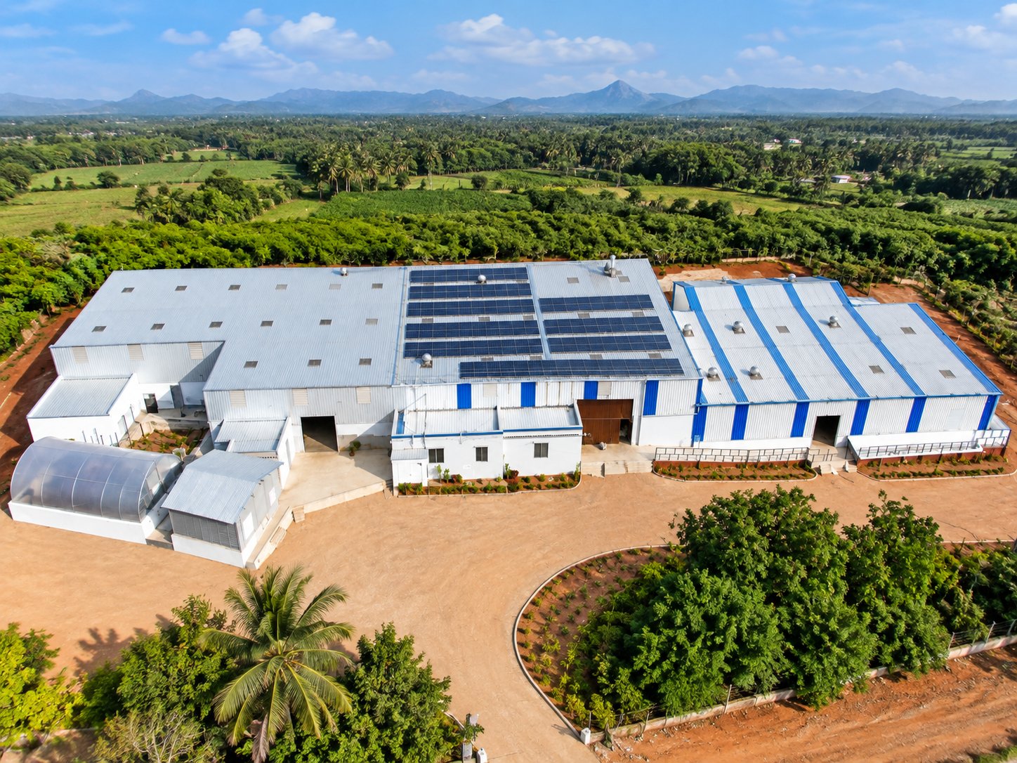Aerial drone view of the Even More Foods manufacturing facility surrounded by farmland