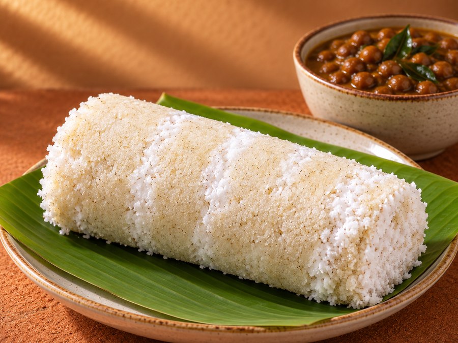 Steamed puttu served with a side curry